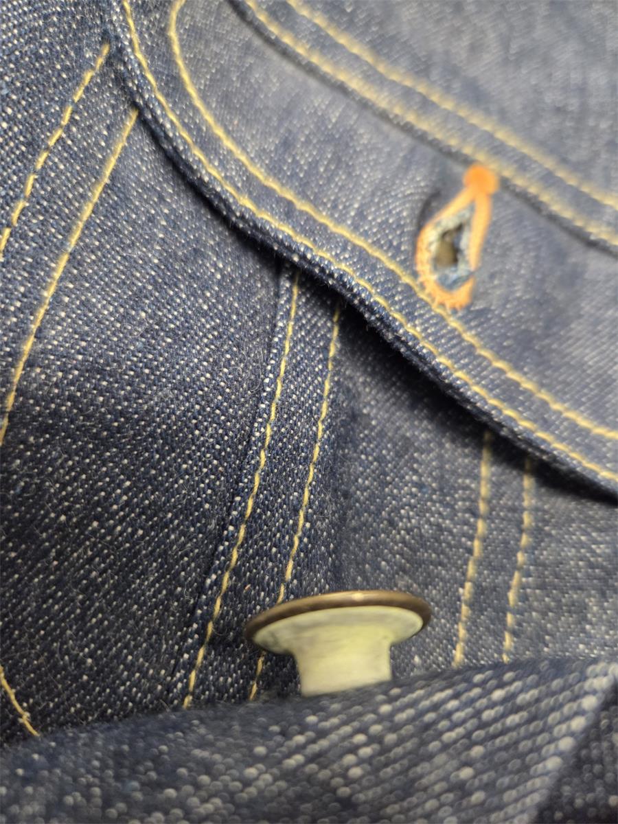 The metal used to make the back of the tack style button has turned yellow and it does rub off.